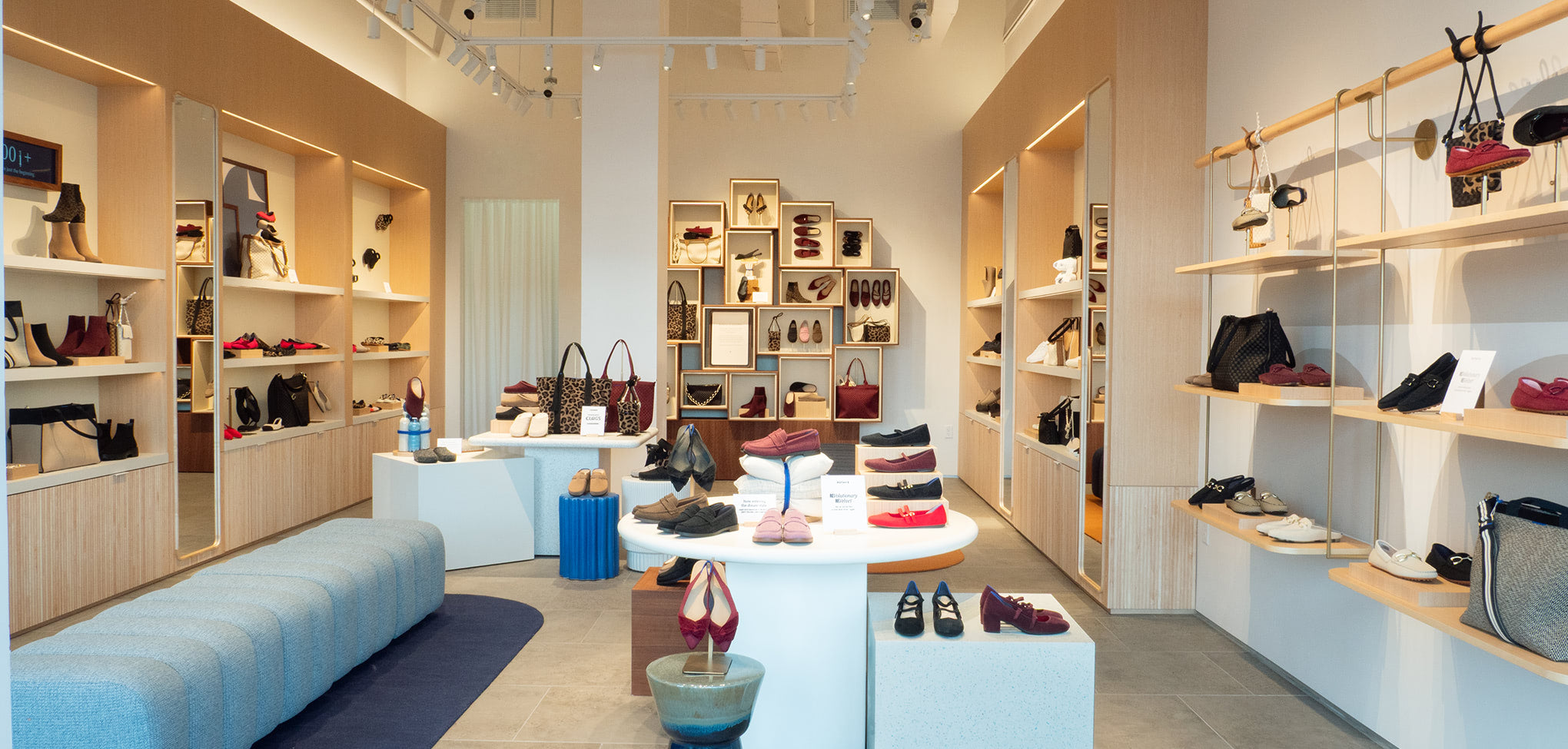 Rothy’s interior store with shelves and display tables featuring various shoes, at Legacy Place, Dedham, MA.