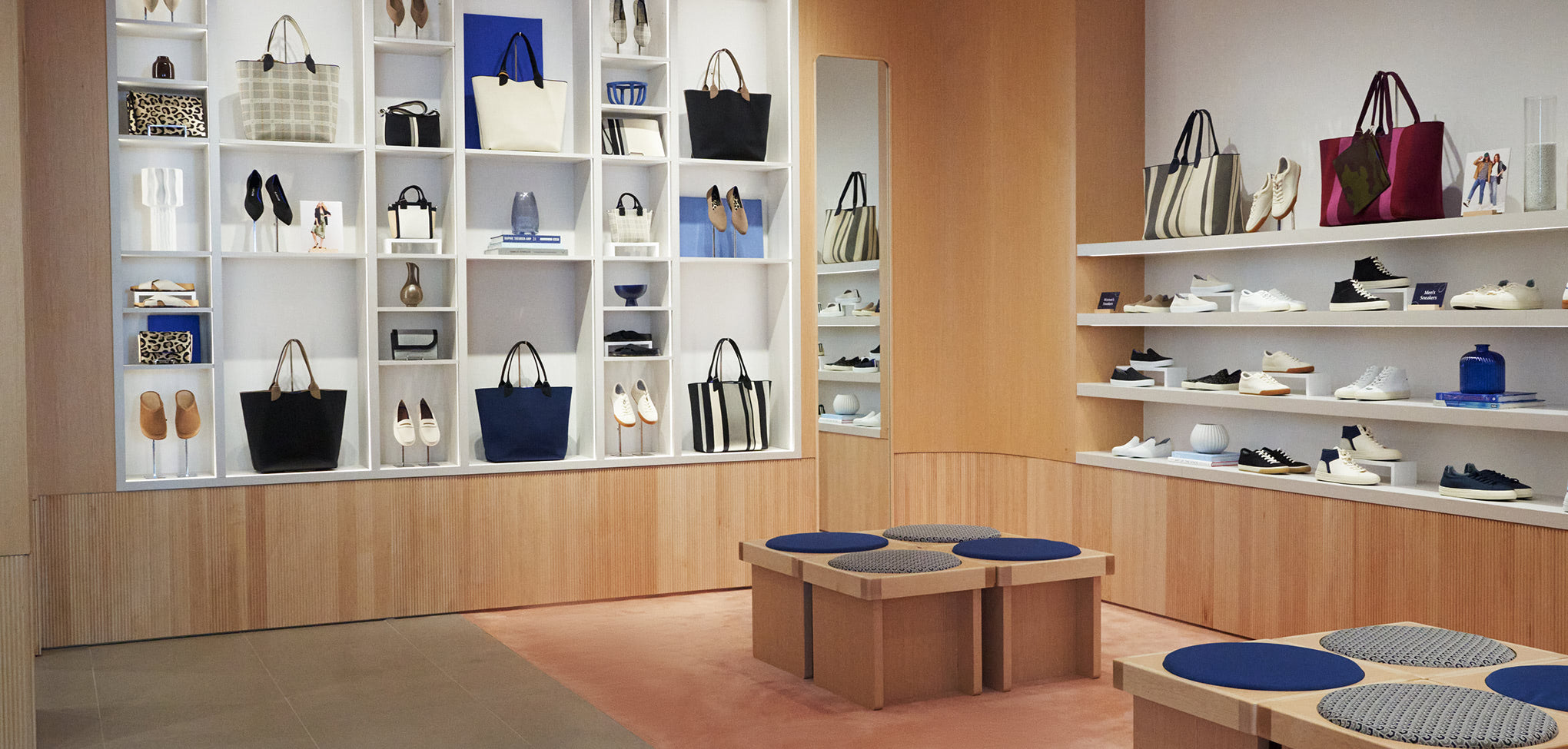 Rothy's interior store Display of handbags in a store with shelves and tables.