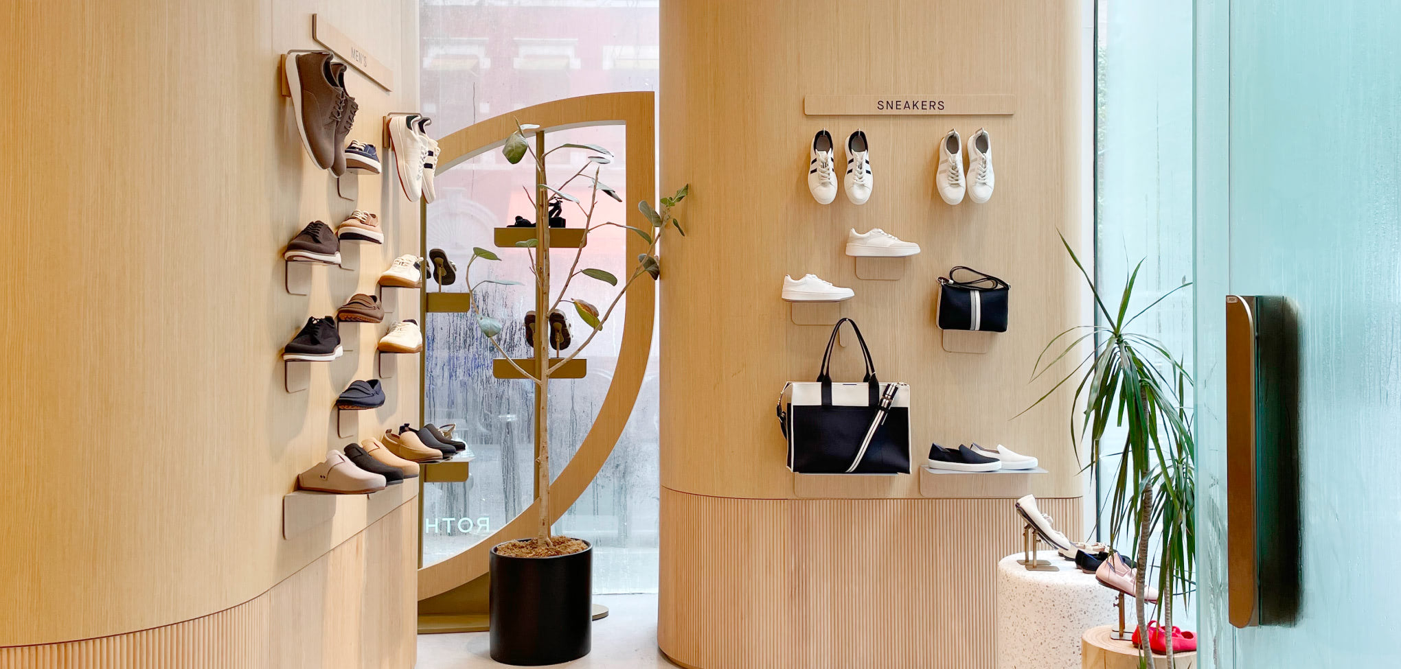 Rothy's interior store Wall-mounted shoe rack with various shoes on a wooden wall