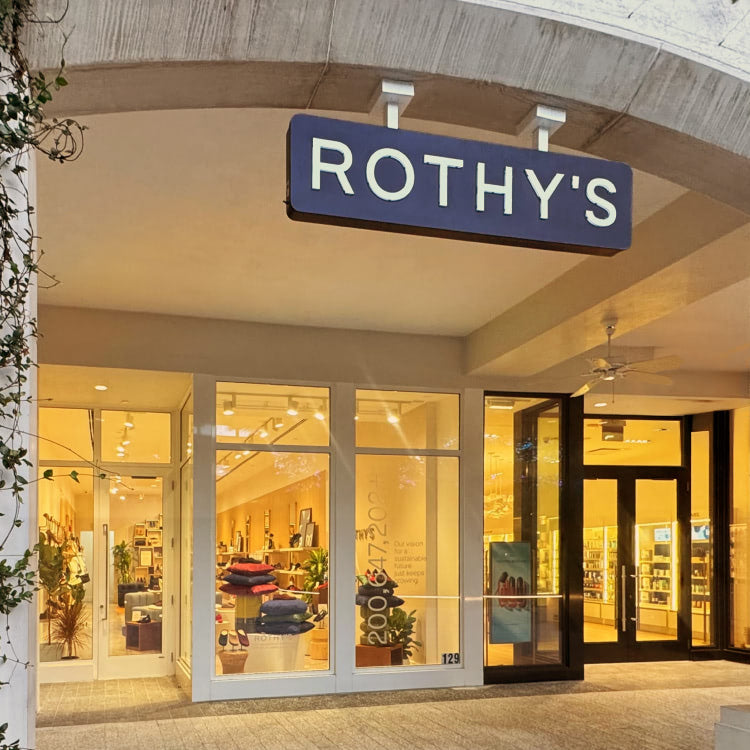Entrance to Rothy's CityPlace store with glass doors and interior lighting.
