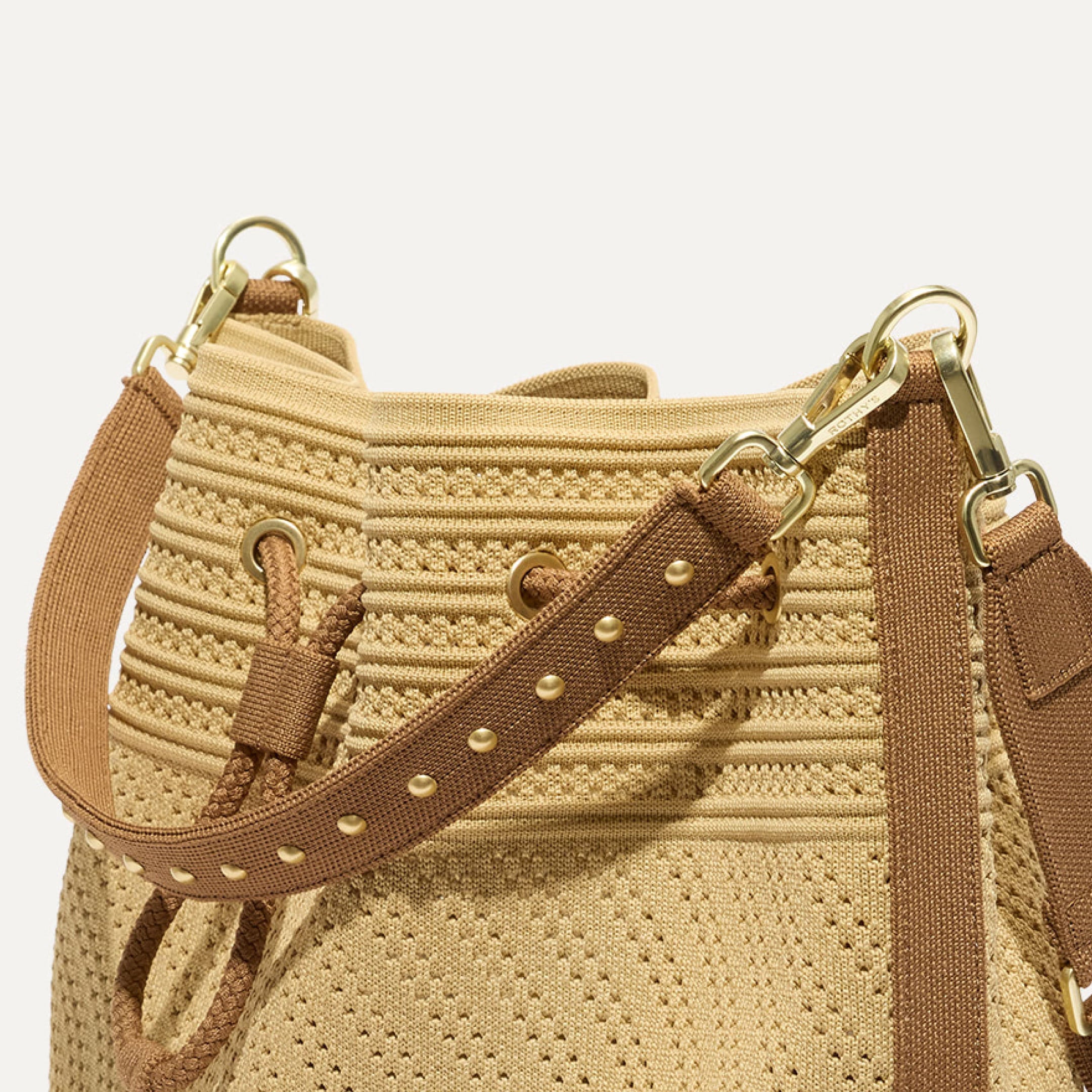 Close up of The Cinch Bucket Bag	Brown Butter Crochet showcasing the studded removable handle.