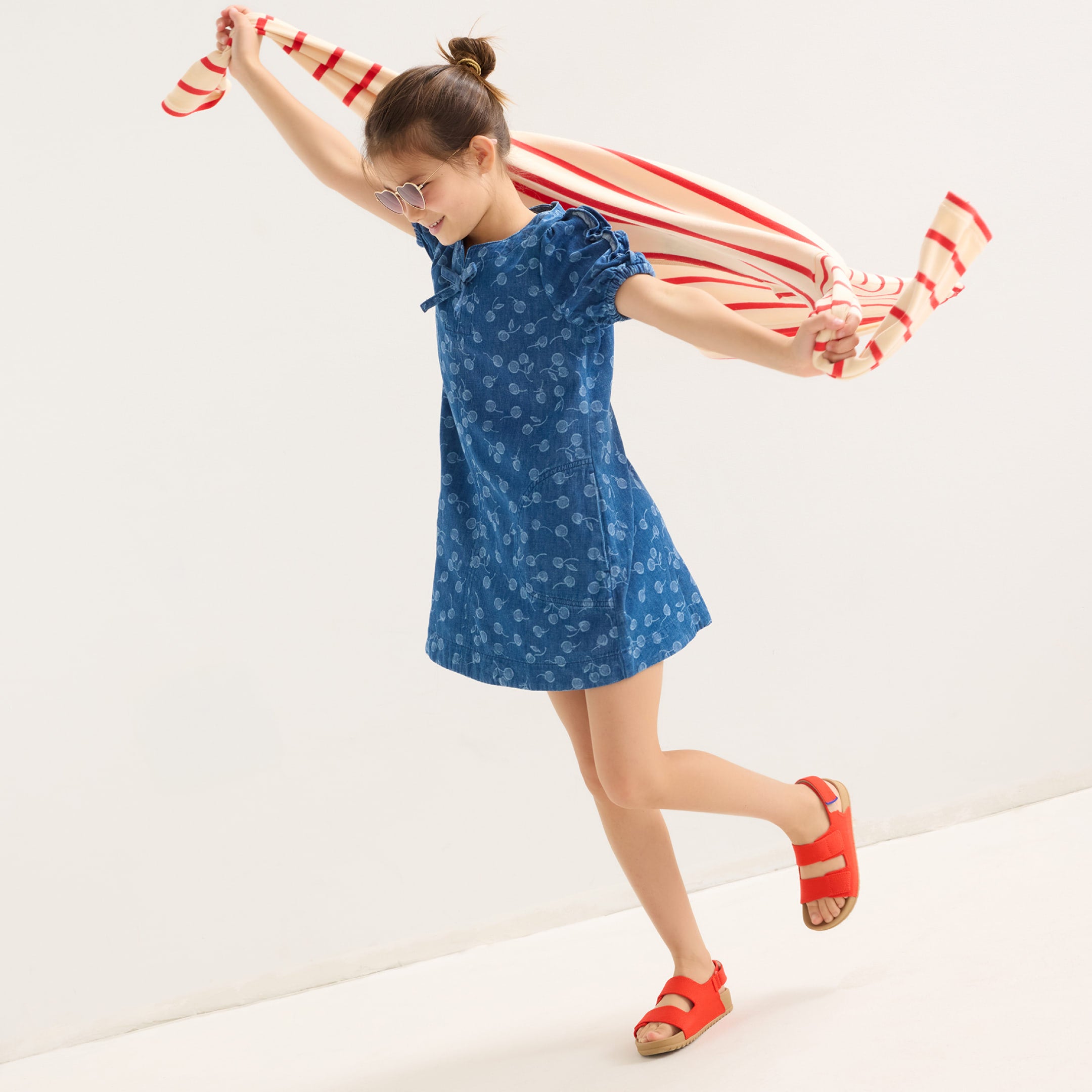 A child wearing The Kids Double Strap Sandal.