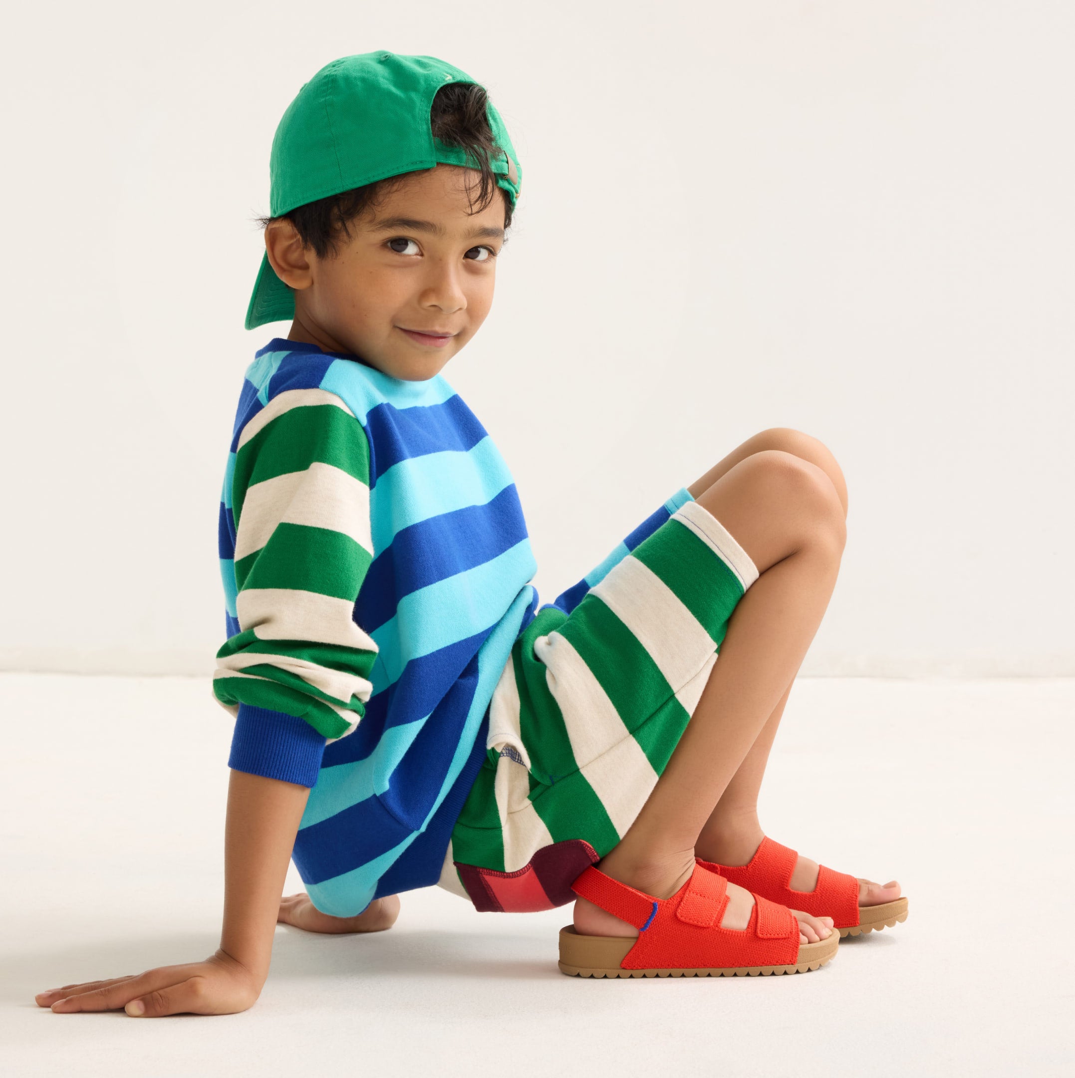 A child wearing The Kids Double Strap Sandal. 