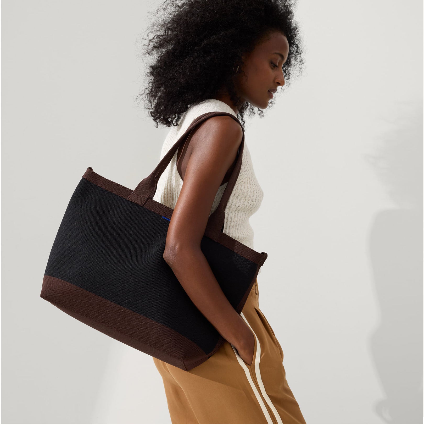 Model holding The Lightweight Zip Tote.