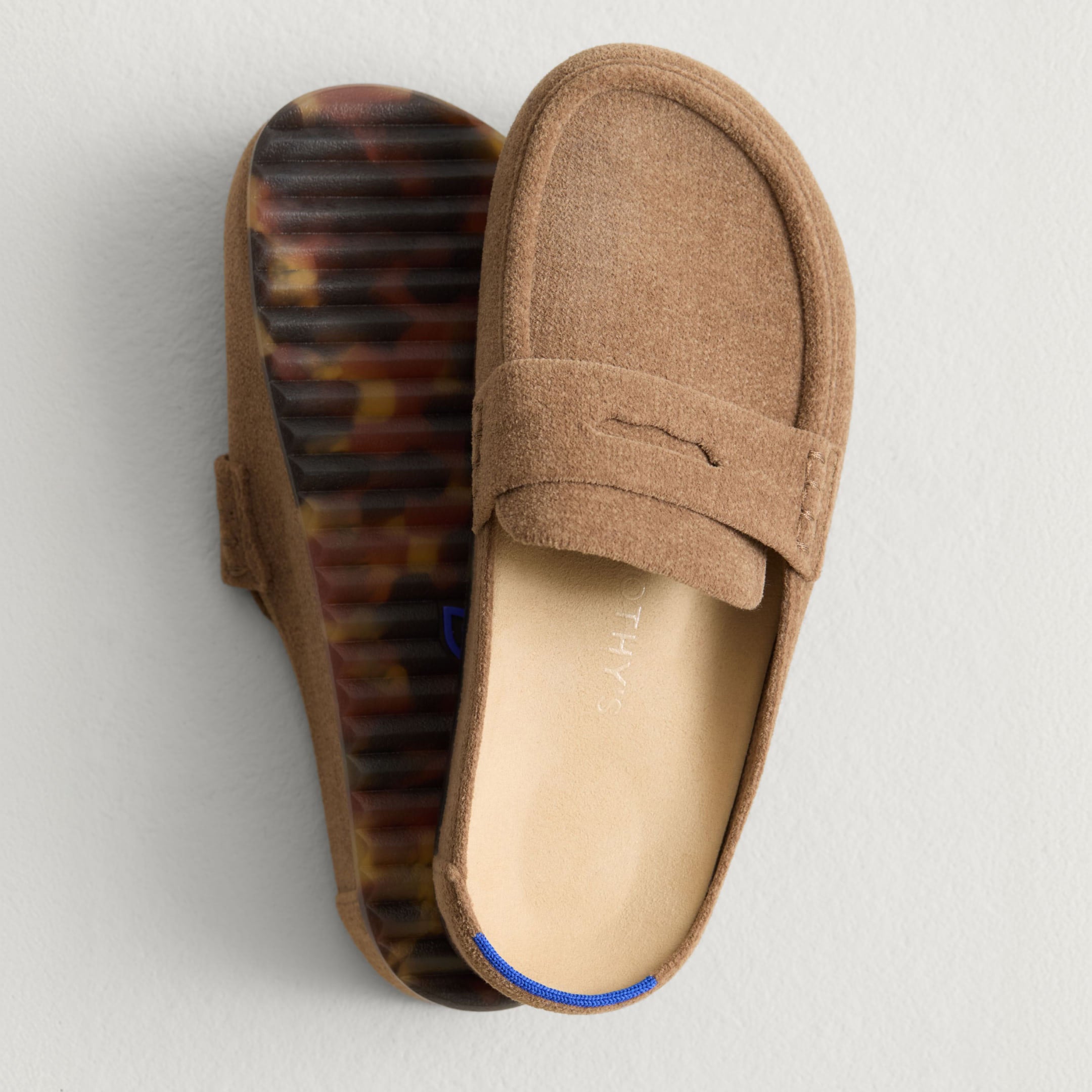 Close up overhead view of The Penny Clog, showing the top and bottom outsole of the shoe. 