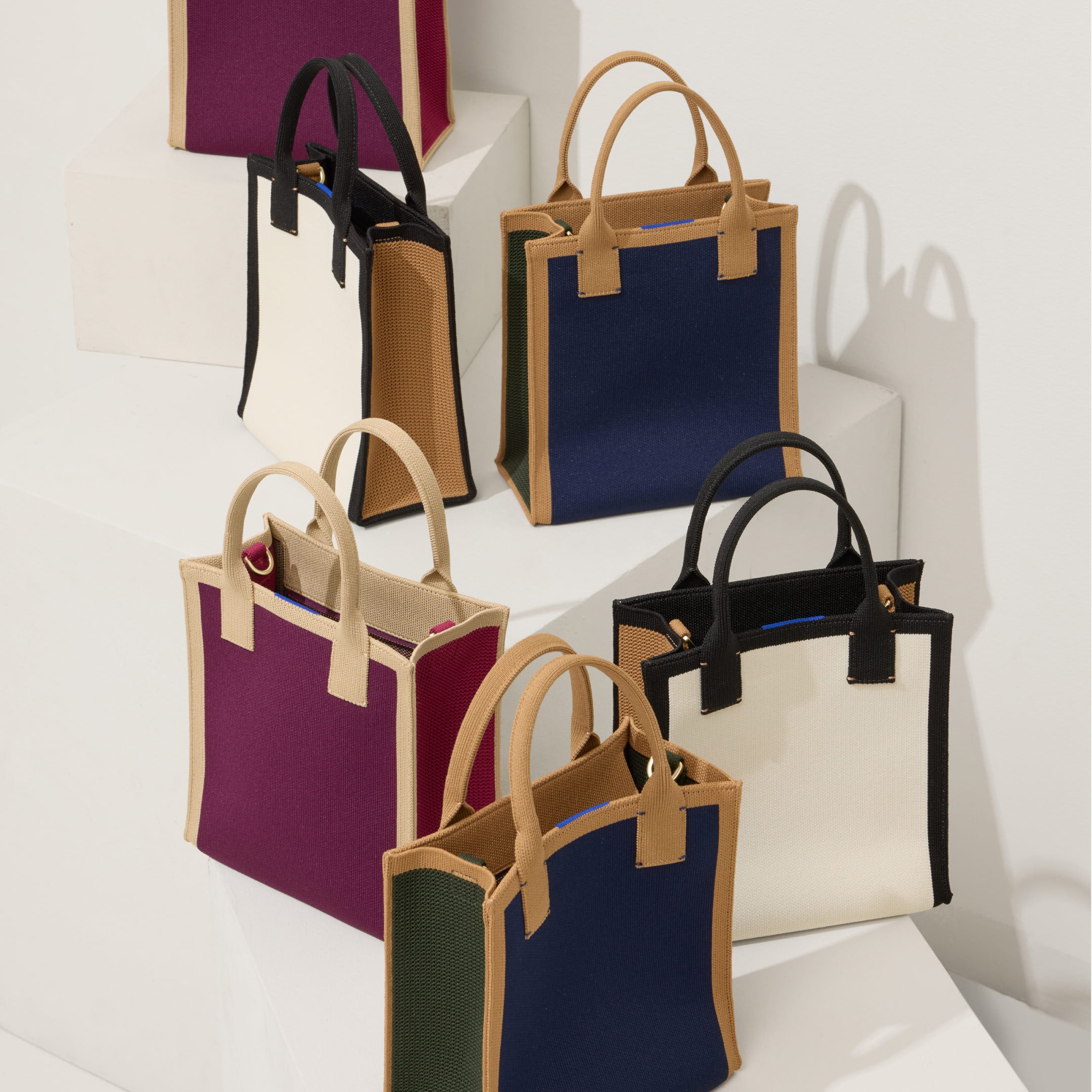 The Petite Classic Tote shown in multiple colors.