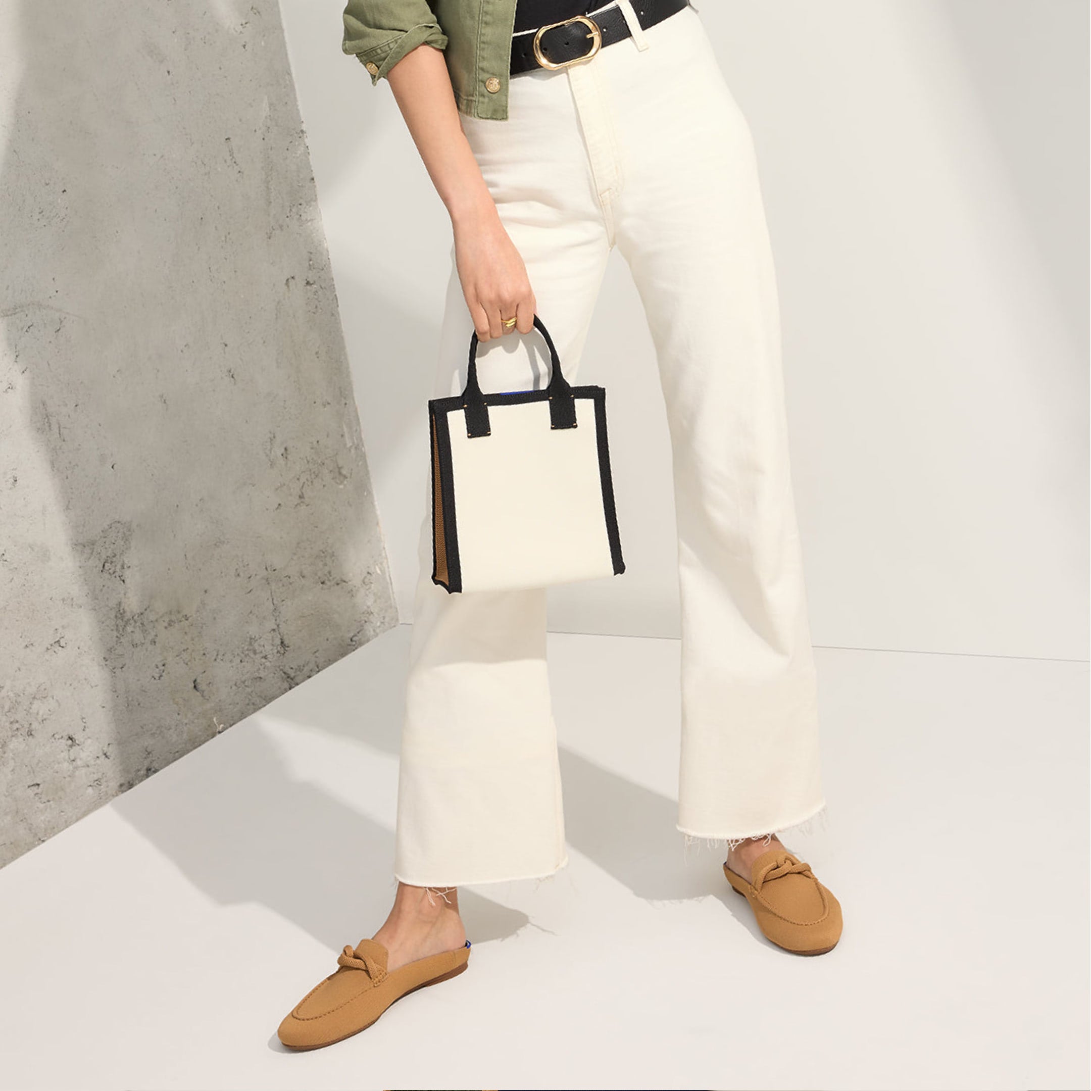 Model holding The Petite Classic Tote.