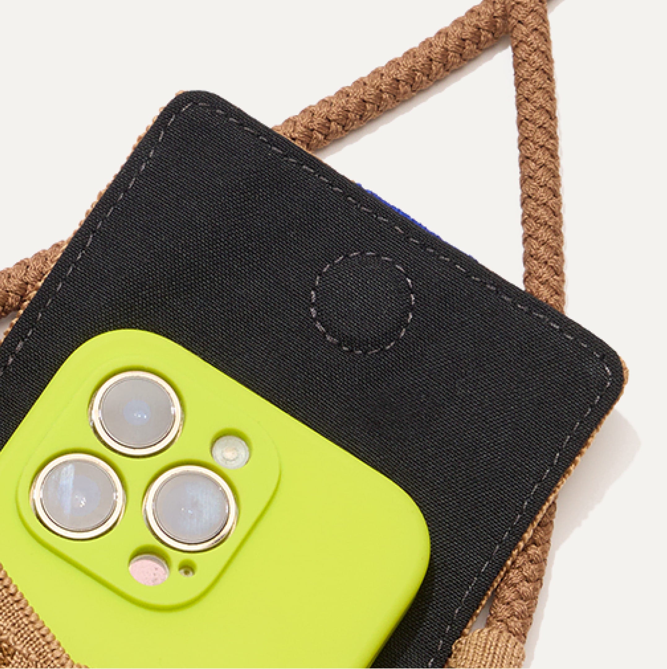 A close up of The Phone Crossbody with an iPhone inside.