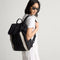 hover | Model carrying The Travel Cinch Backpack in Ink shown from the front.