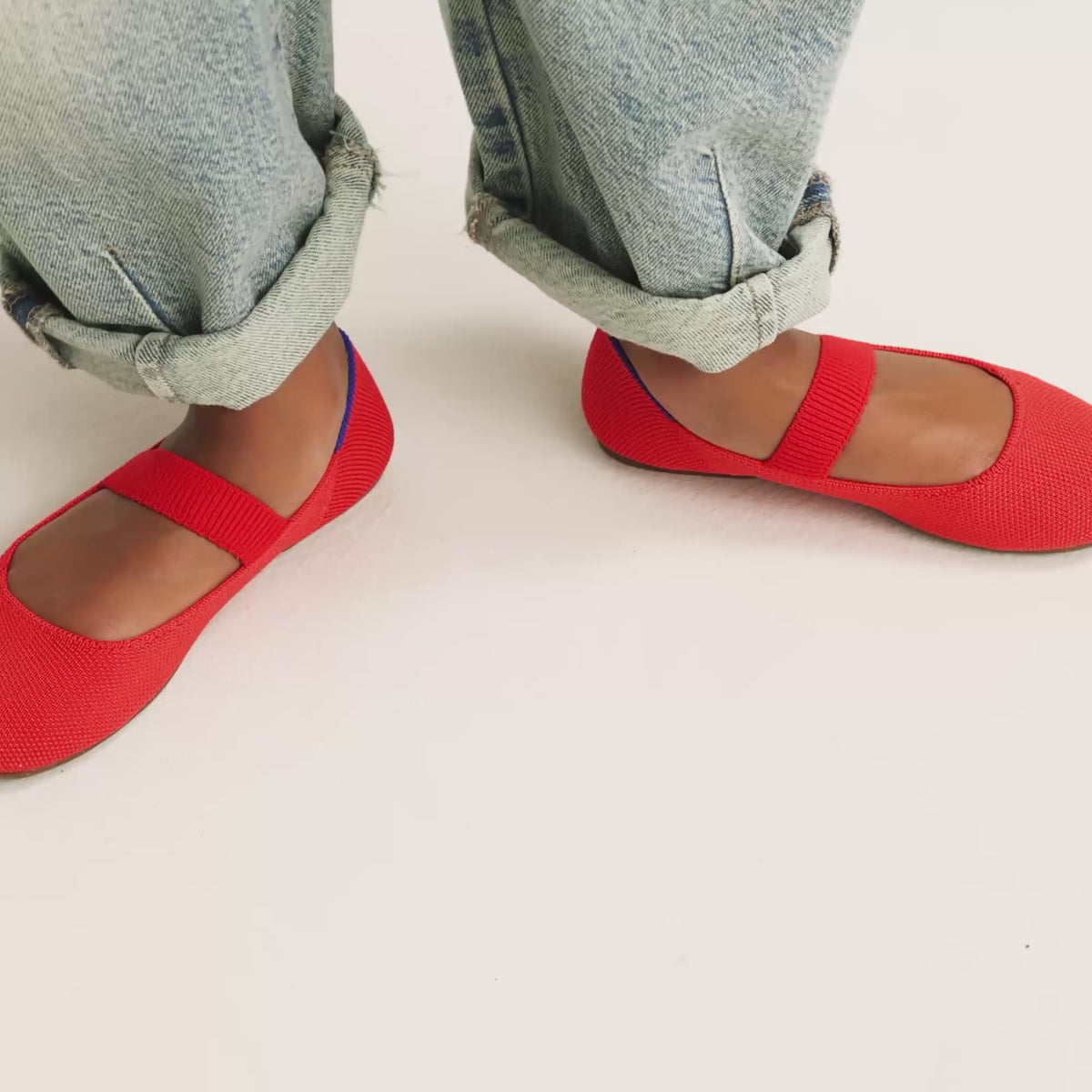 model | An alternate image of a model walking in The Kids Mary Jane in Glamour Red and showing different angles of the shoes. 