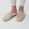 Model walking in The Scuff Slipper in Birch Tan and showing different angles of the shoes.