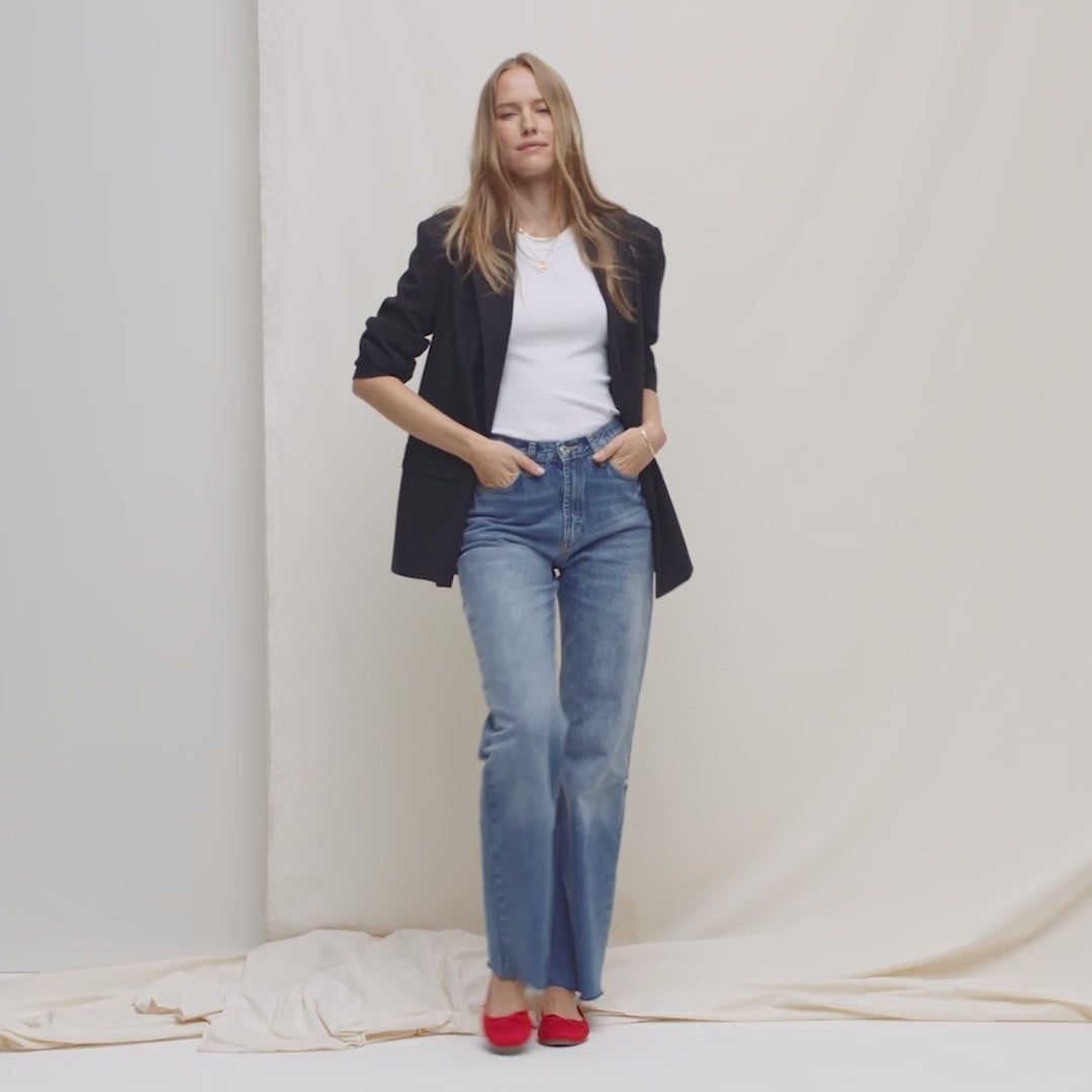 Model walking in The Ballet Flat in Glamour Red and showing different angles of the shoes.