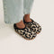 Model walking in The Kids Clog in Desert Cat and showing different angles of the shoes. 