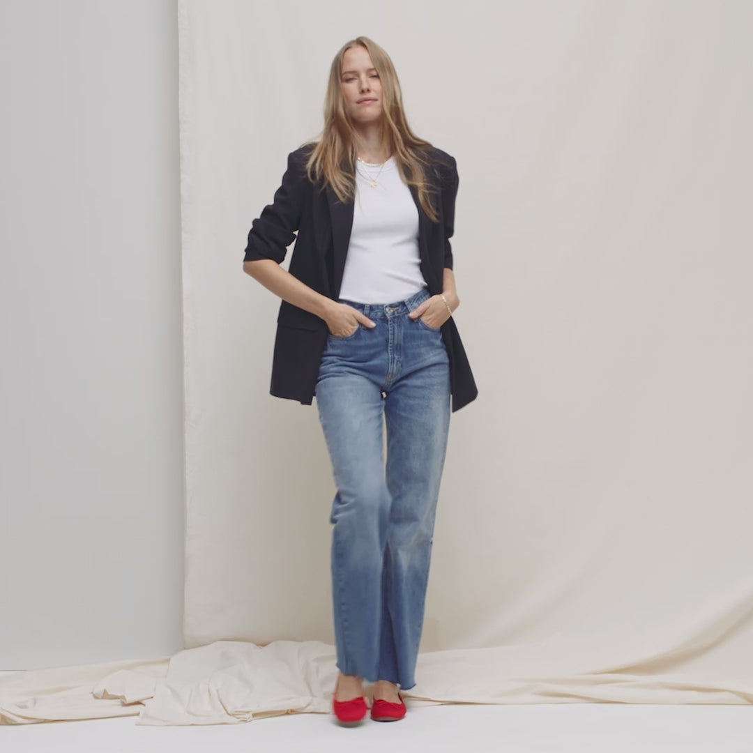 Model walking in The Ballet Flat in Glamour Red and showing different angles of the shoes.