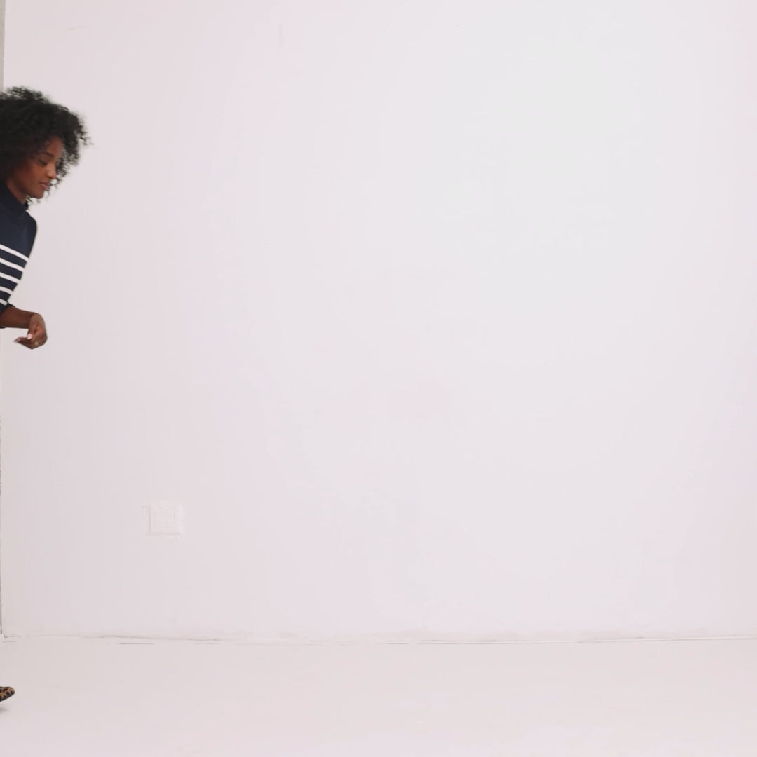 Model wearing The Daily Flat and showing different angles of the shoe.