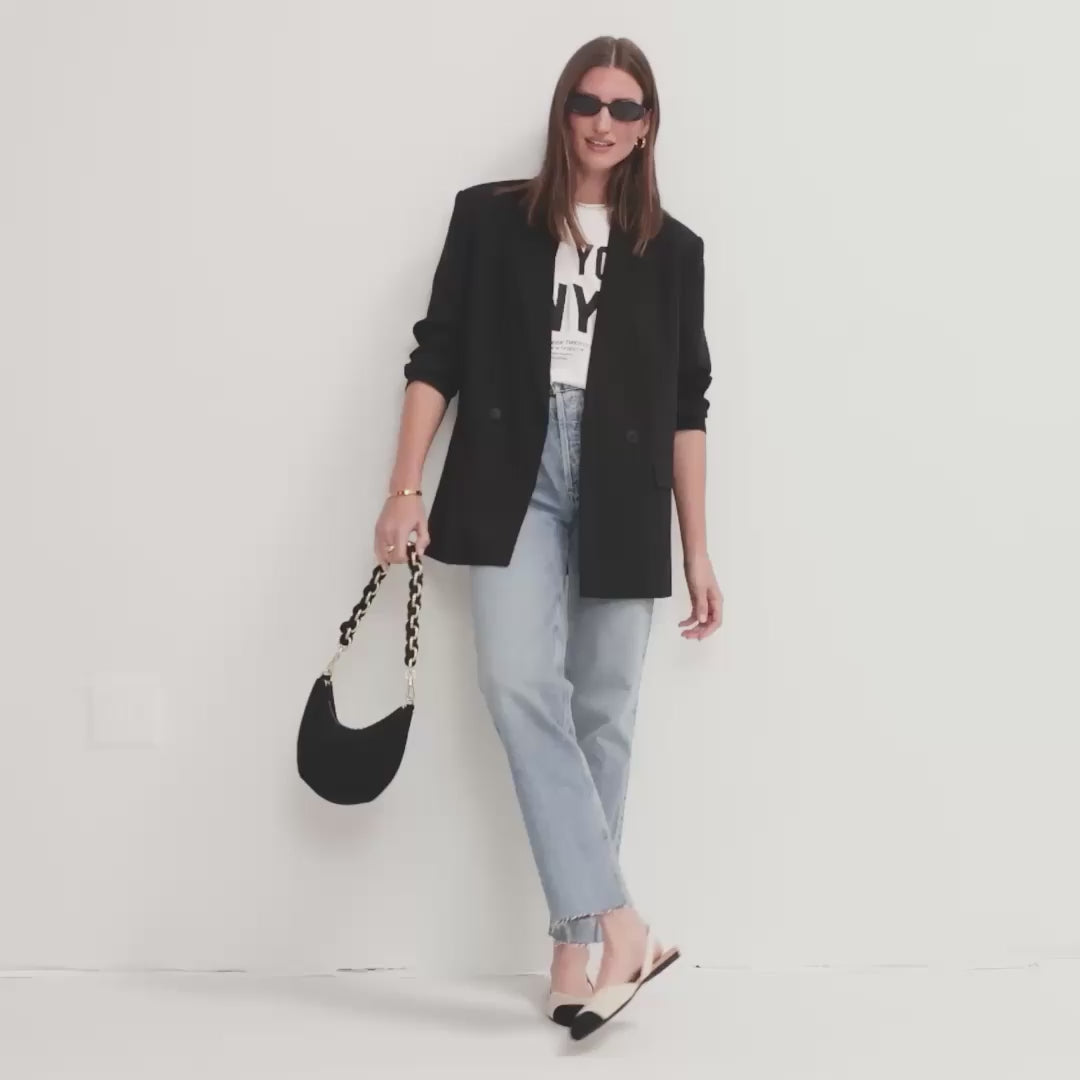 Model walking in The Almond Slingback in Conch Captoe and showing different angles of the shoes. 