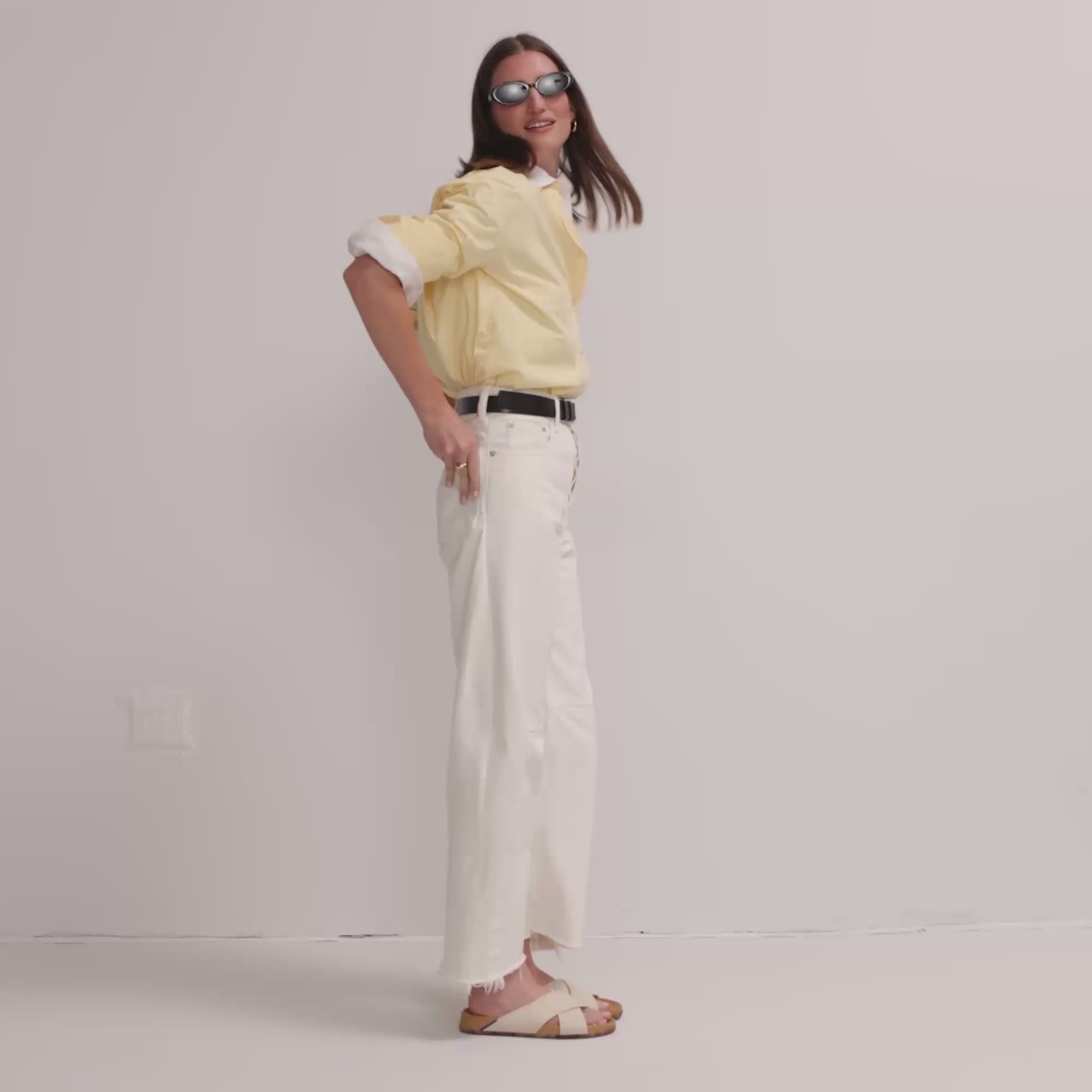 Model walking in The Weekend Slide in Oat and showing different angles of the sandals. 