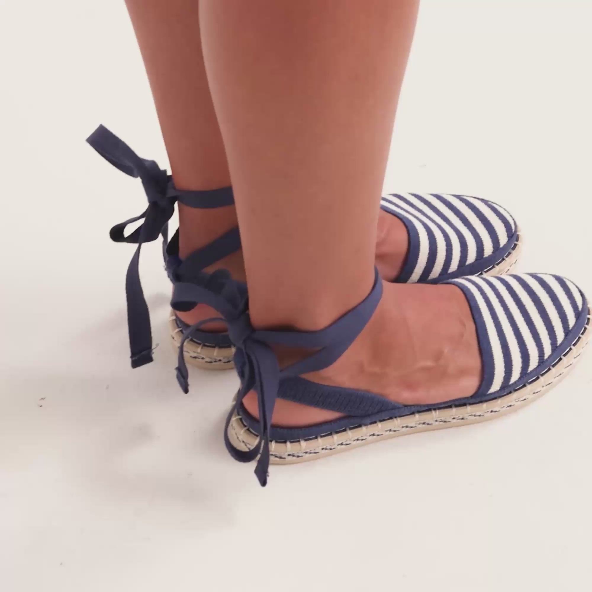 Model walking in The D'Orsay Espadrille in Sailor Stripe while showing different angles of the shoes. 