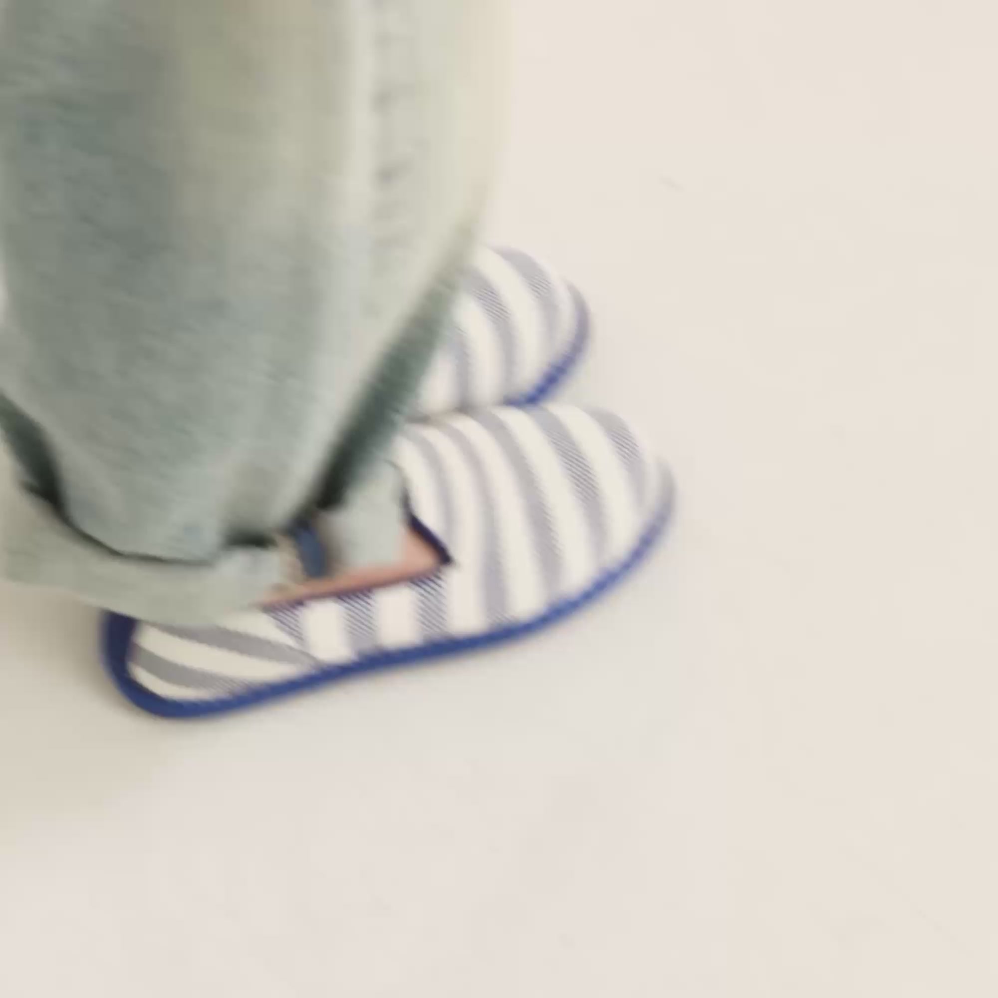 Model walking in The Mini Loafer in Harbor Stripe and showing different angles of the shoes. 