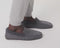 Model walking in The Men's Slipper in Mountain Grey and showing different angles of the shoes. 
