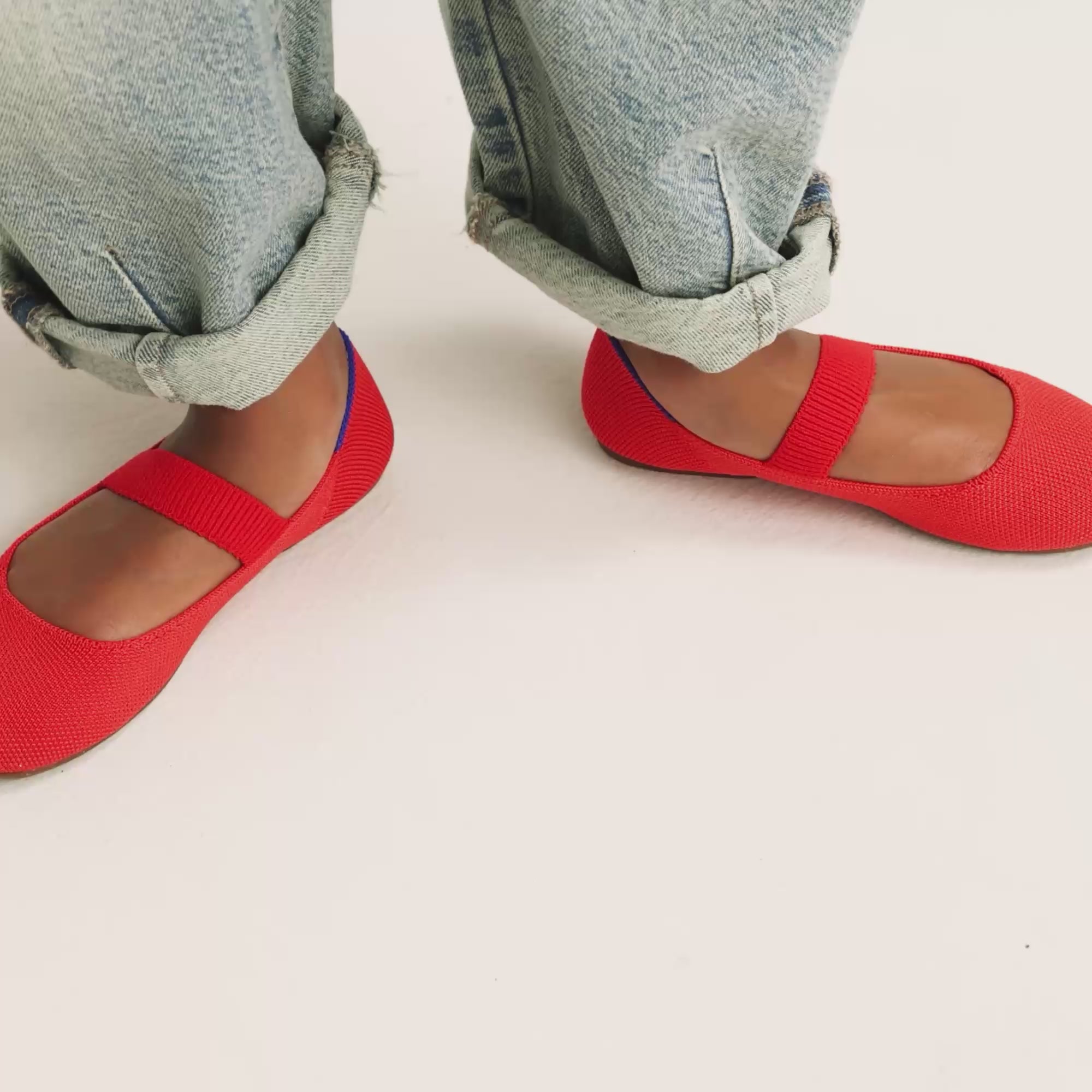 Model walking in The Kids Mary Jane in Glamour Red and showing different angles of the shoes. 