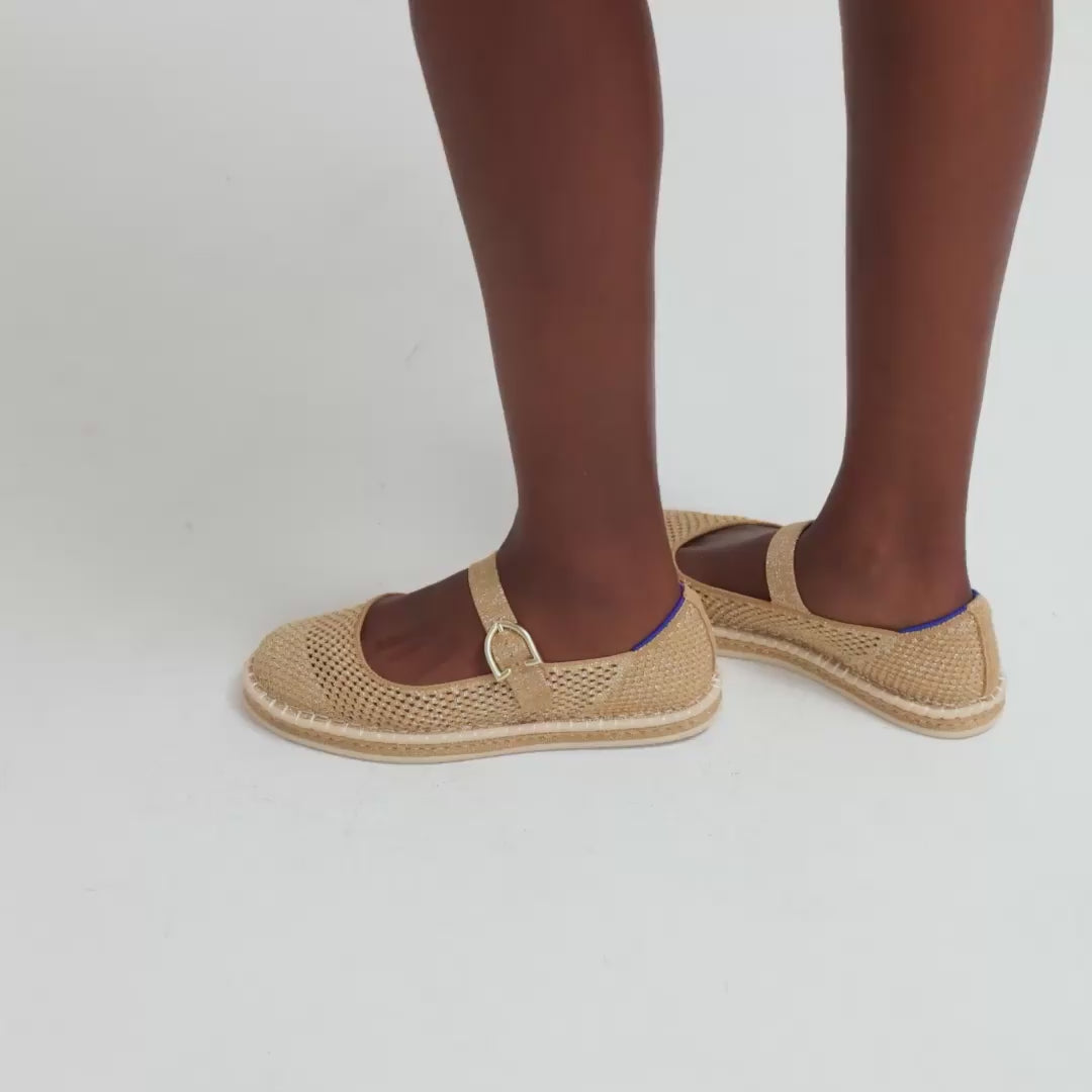 Model moving around in The Espadrille Mary Jane in Metallic Golden Sun, showing different angles of the shoe. 