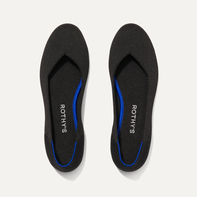 A pair of The Flat round toe shoes in Black Solid shown from the top view.