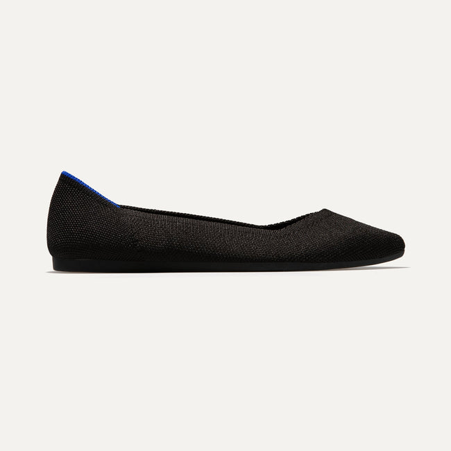 The Point shoe in Black Solid shown from a side view showing the outsole.