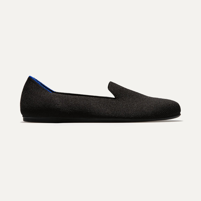 The Loafer in Black Solid shown from a side view showing the outsole.