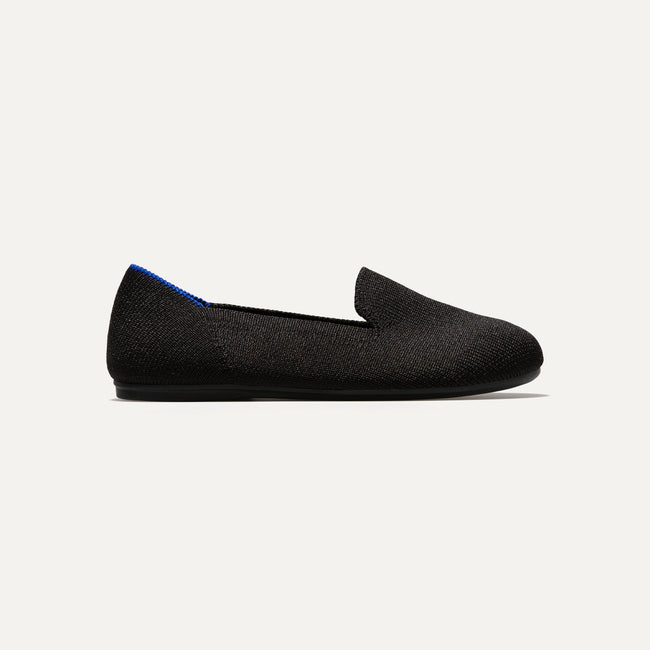 The Kids slip-on Loafer in Black Solid shown from a side view showing the outsole.