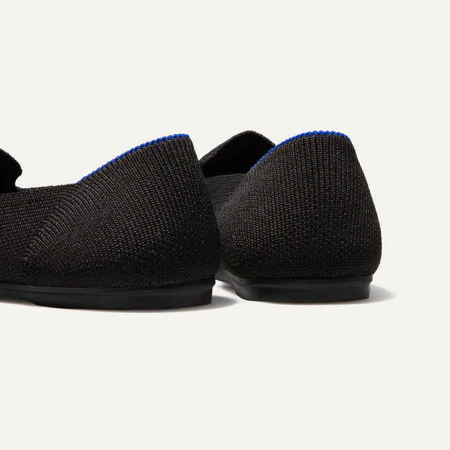 The Kids slip-on Loafer in Black Solid shown from the back view with the heel detail.