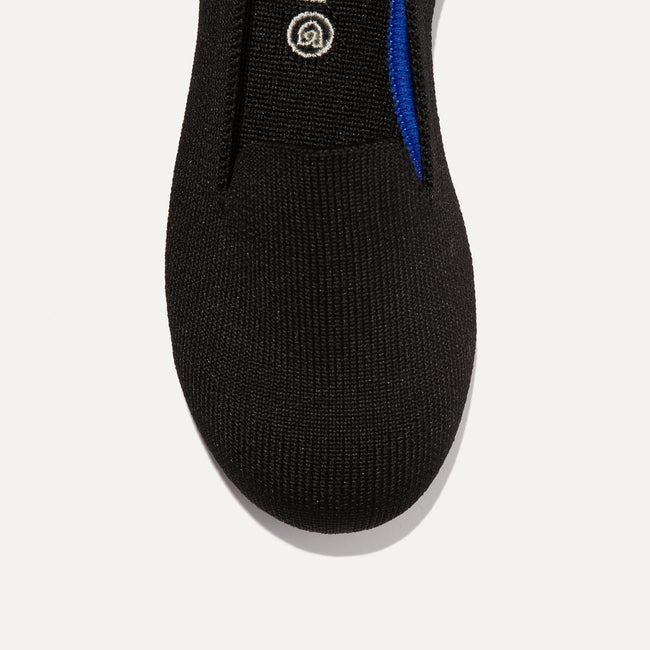 The Kids slip-on Loafer in Black Solid shown from the top view with detailing of the front of the shoe.