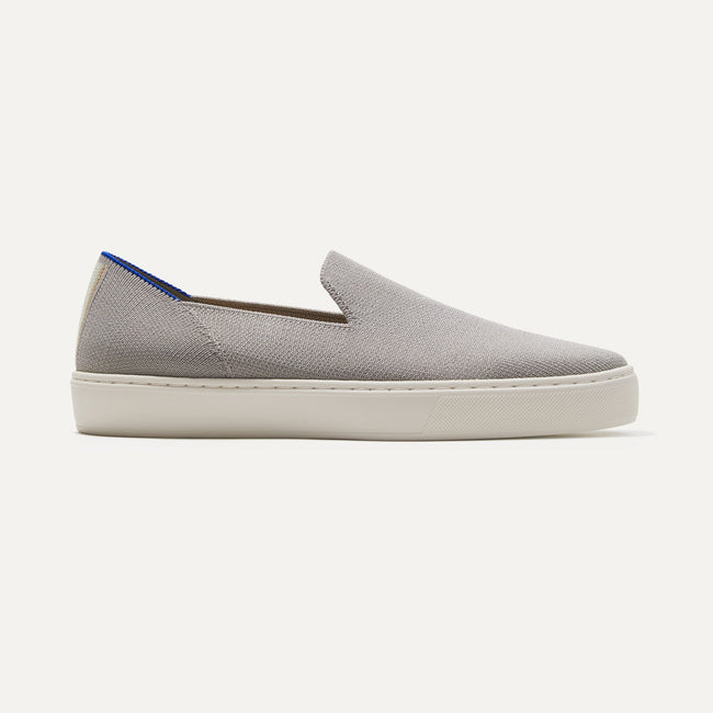 The Sneaker in Light Grey shown from the side. 