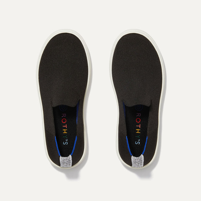 A pair of The Kids slip-on Sneakers in Black shown from the top view.