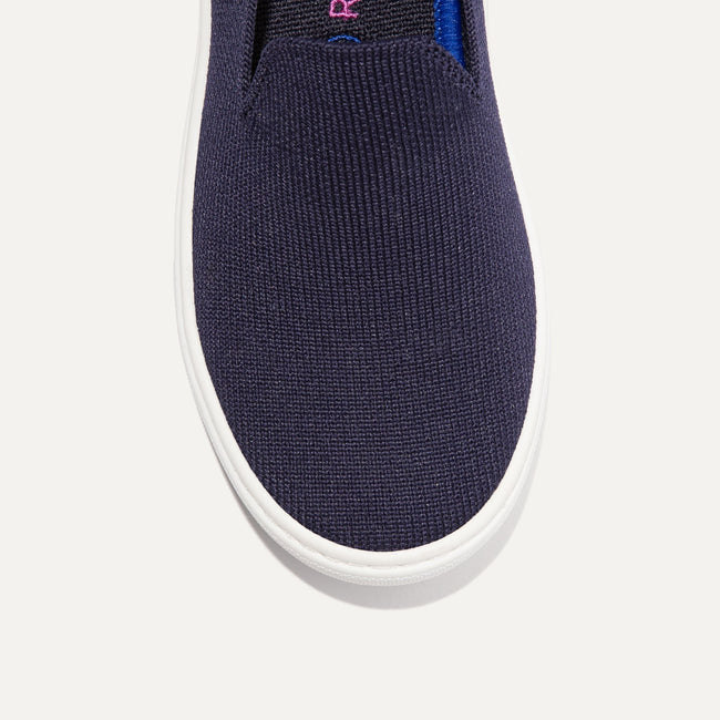 The Kids slip-on Sneaker in Deep Navy shown from the top view with detailing of the front of the shoe.
