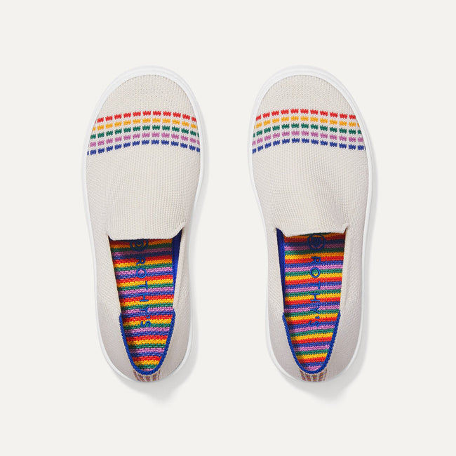 A pair of The Kids slip-on Sneakers in White Rainbow shown from the top view.