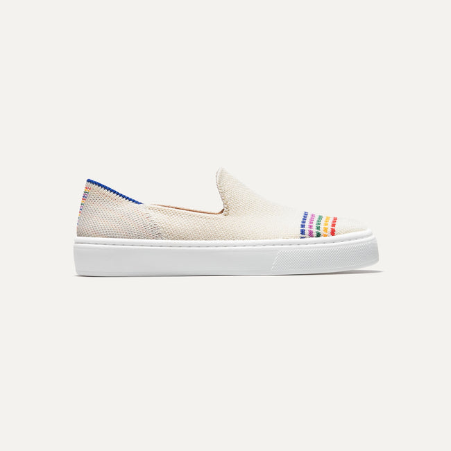 The Kids slip-on Sneaker in White Rainbow shown from a side view showing the outsole.