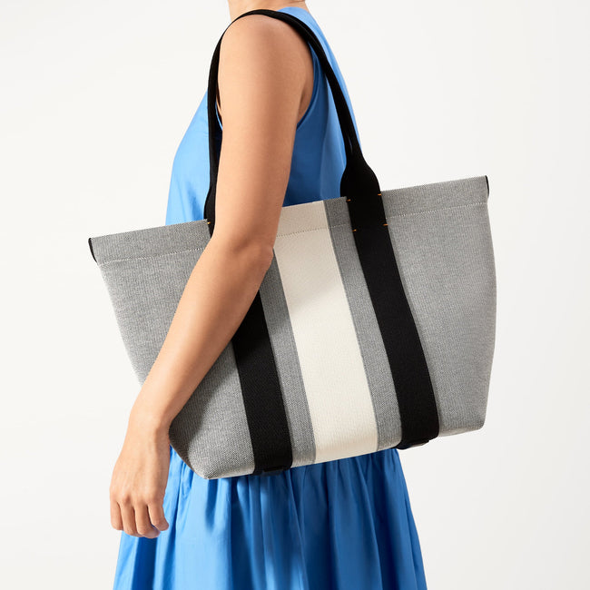 The Essential Tote in Grey Mist worn by a model.