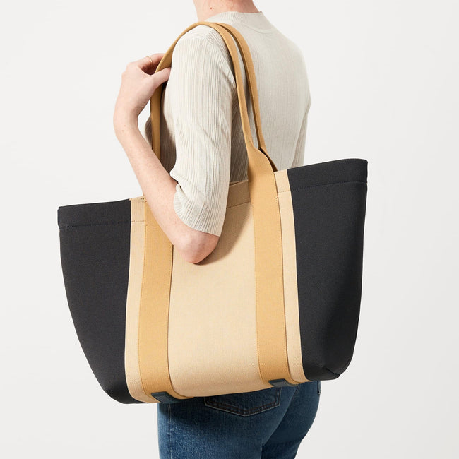 The Essential Tote in Ink and Ivory shown on model.