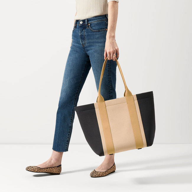 The Essential Tote in Ink and Ivory shown on model in an alternate view.