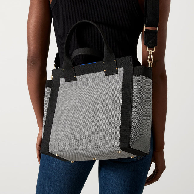 hover | The Handbag in Grey Mist close up of adjustable, detachable strap with warm gold hardware.