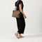 The Handbag in Black Cocoa shown on model in a different pose. 