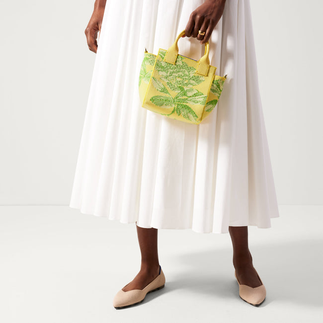 hover | The Mini Handbag in Limoncello Floral shown on model. 