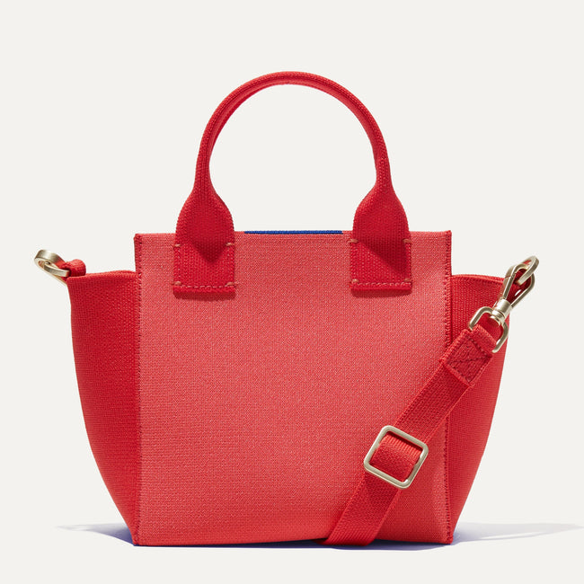The Mini Handbag in Ruby Grapefruit shown from the front.