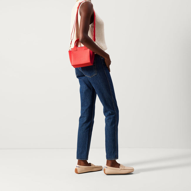 The Mini Handbag in Ruby Grapefruit shown on model.