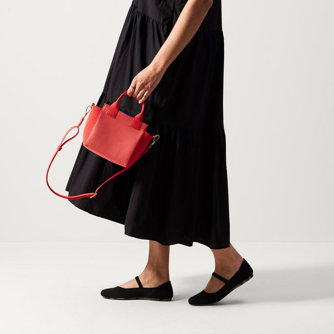 hover | The Mini Handbag in Ruby Grapefruit shown on model. 