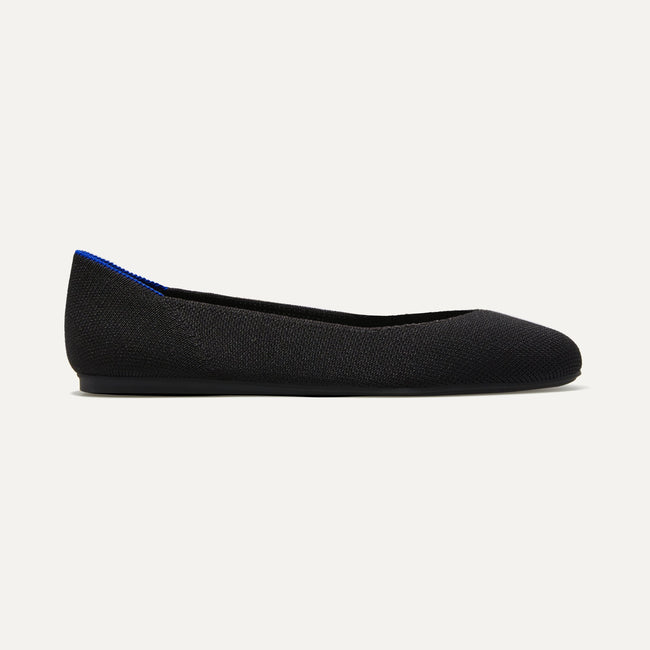 The Square toe flat shoe in Black shown from a side view showing the outsole.