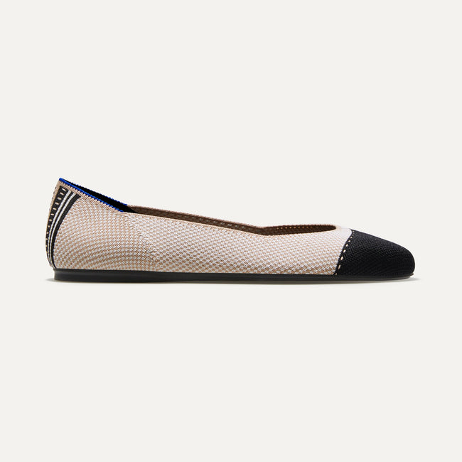 The Square toe flat shoe in Tuxedo shown from a side view showing the outsole.