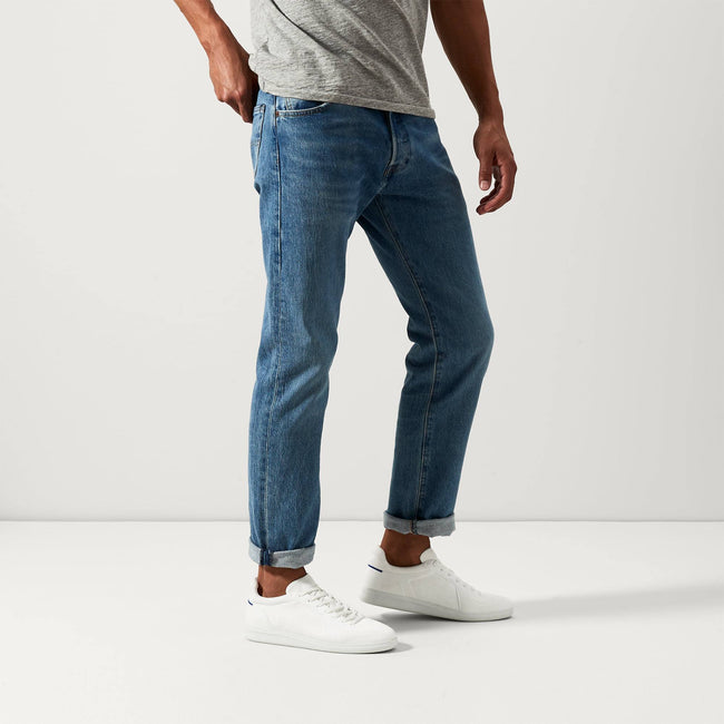 Alternate view of a model wearing The RS01 Sneaker in White. 
