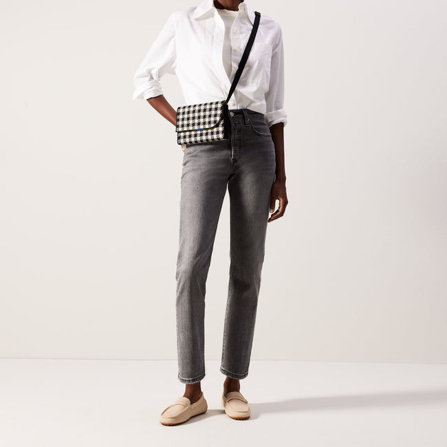Another view of model wearing The Belt Bag in Black and Canvas Gingham.